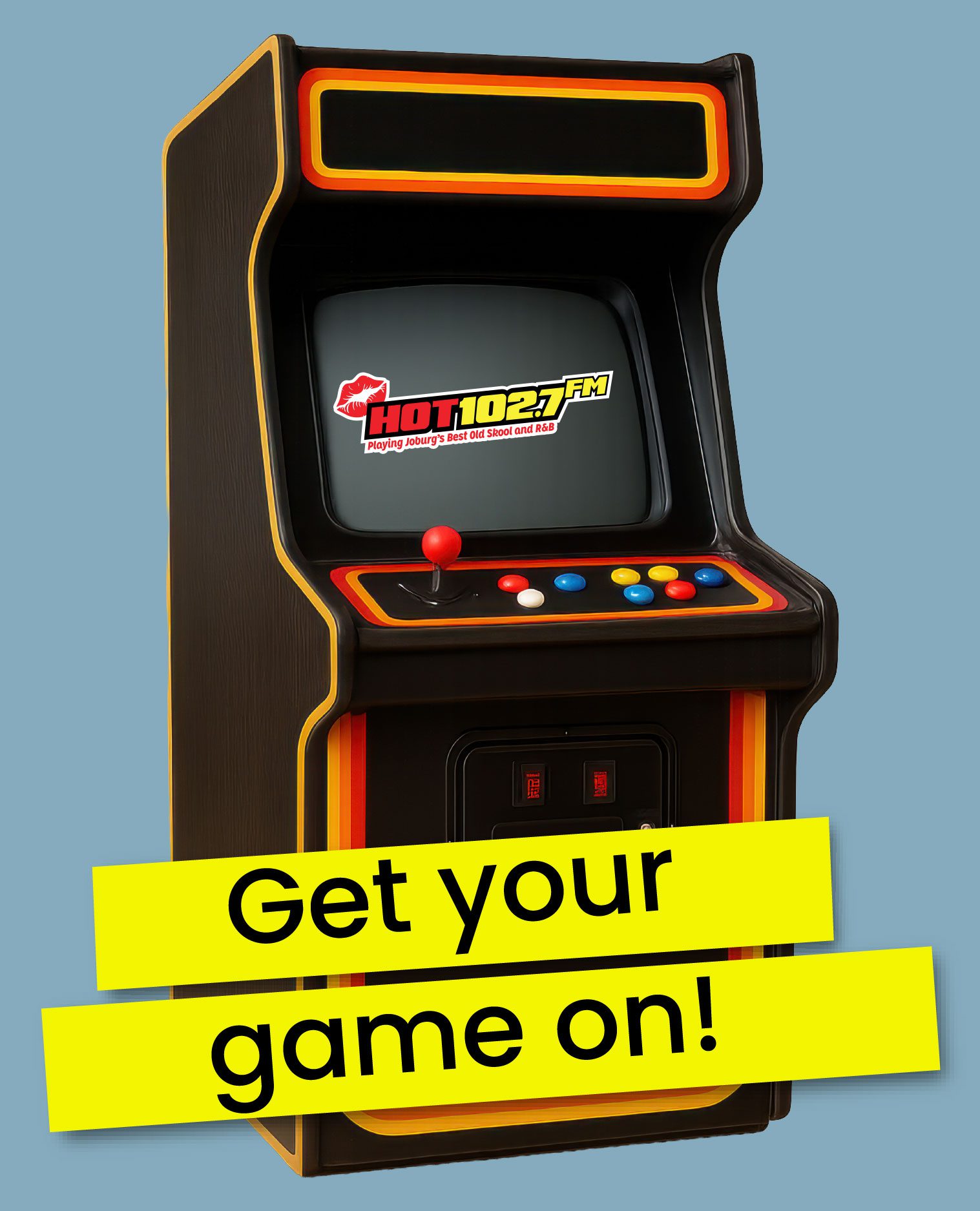 A retro arcade game machine with a joystick and buttons is shown. The screen displays the HOT 102.7 FM logo. Bold yellow text across the bottom reads, Get your game on!.