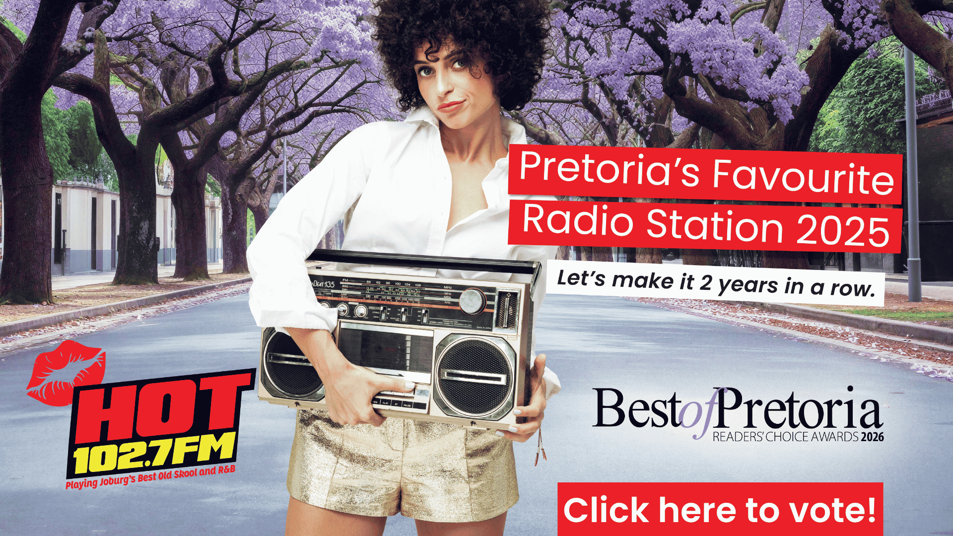 A woman with curly hair holds a large boombox while standing on a jacaranda-lined street. Text promotes HOT 102.7FM as Pretorias Favourite Radio Station 2025 and encourages people to vote for the Best of Pretoria awards.